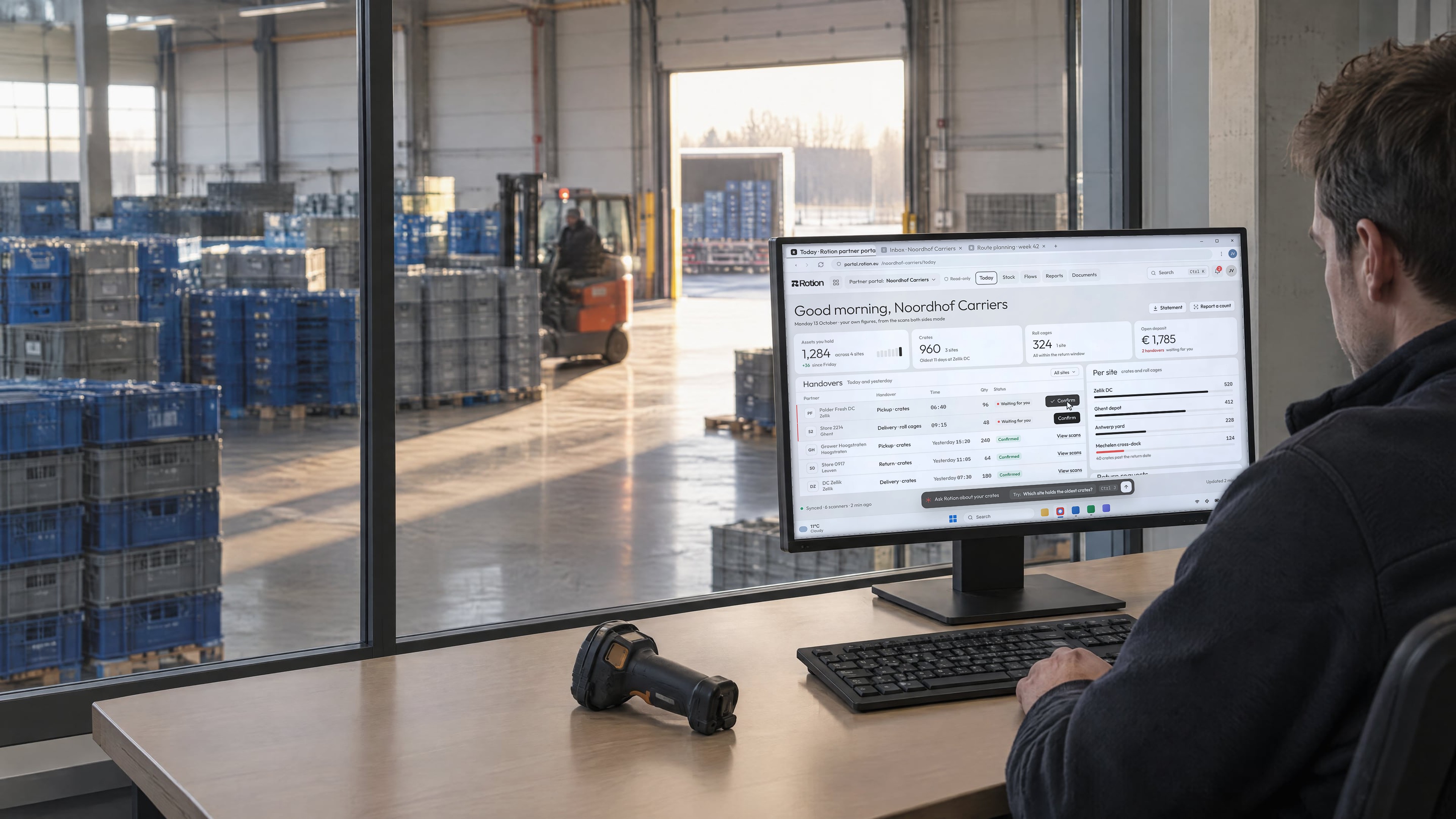 A planner at a mezzanine desk overlooking a crate pooling hall, the monitor showing the Rotion partner portal with handovers waiting to be confirmed